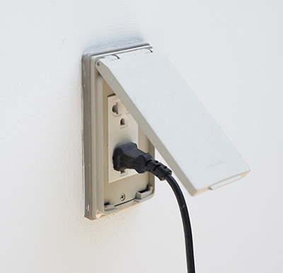 Outdoor outlet with a weatherproofing cover